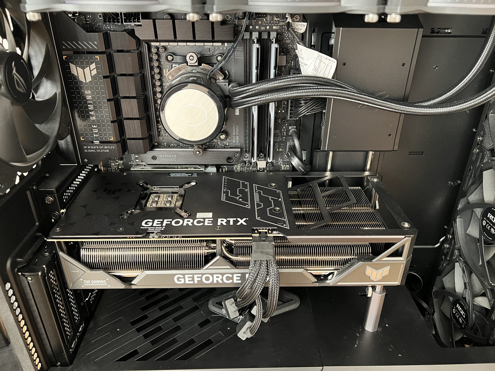 The RTX 4090 in the top PCIe slot with the side panel off. The card is thick enough to cover the slot below it